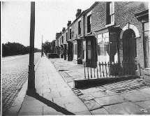 [terraced houses and cobbled road]