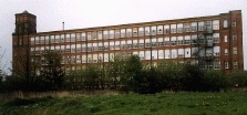 [reb brick mill with many windows]