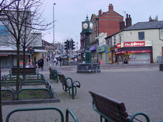 [benches and shops and clock]